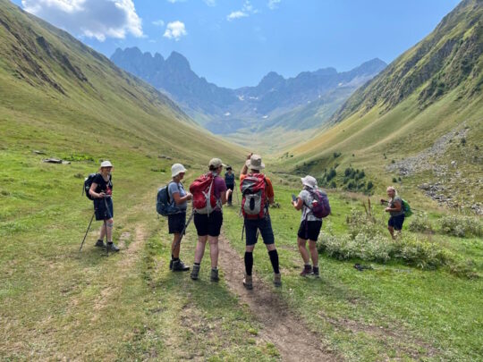 groepje wandelaars in dal in de bergen