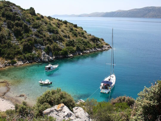 Kleine baai met bootjes en omringd door heuvels in Kroatie